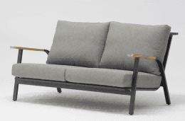 A grey upholstered outdoor ottoman with a dark grey metal frame is shown on a white background.