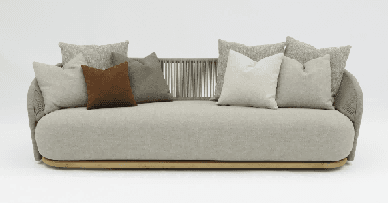 A modern, rectangular coffee table with rounded corners and a light-colored, wood-grain top sits on a light gray base.