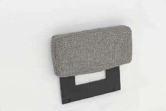A person's hand holds a rectangular, light gray upholstered cushion with dark gray metal legs attached to its underside.
