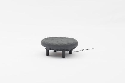 A round, dark gray outdoor fire pit is covered with a protective cover, sitting on a white background.