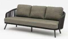 A light-colored outdoor sofa with a woven back and armrests, featuring three seat cushions and three back cushions, all in a matching light fabric, on a white background.
