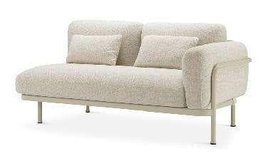 A cream-colored modular corner chair with a textured fabric and a small throw pillow, supported by light-colored metal legs.