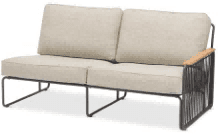A two-seater outdoor sofa with light-colored cushions and a dark metal frame, featuring a wooden armrest on the left side.